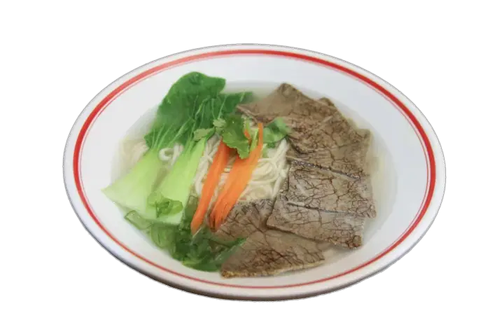 Bowl of Shan's beef noodle soup with tender beef, noodles, greens, and aromatic broth.